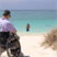 man in wheelchair at a beach